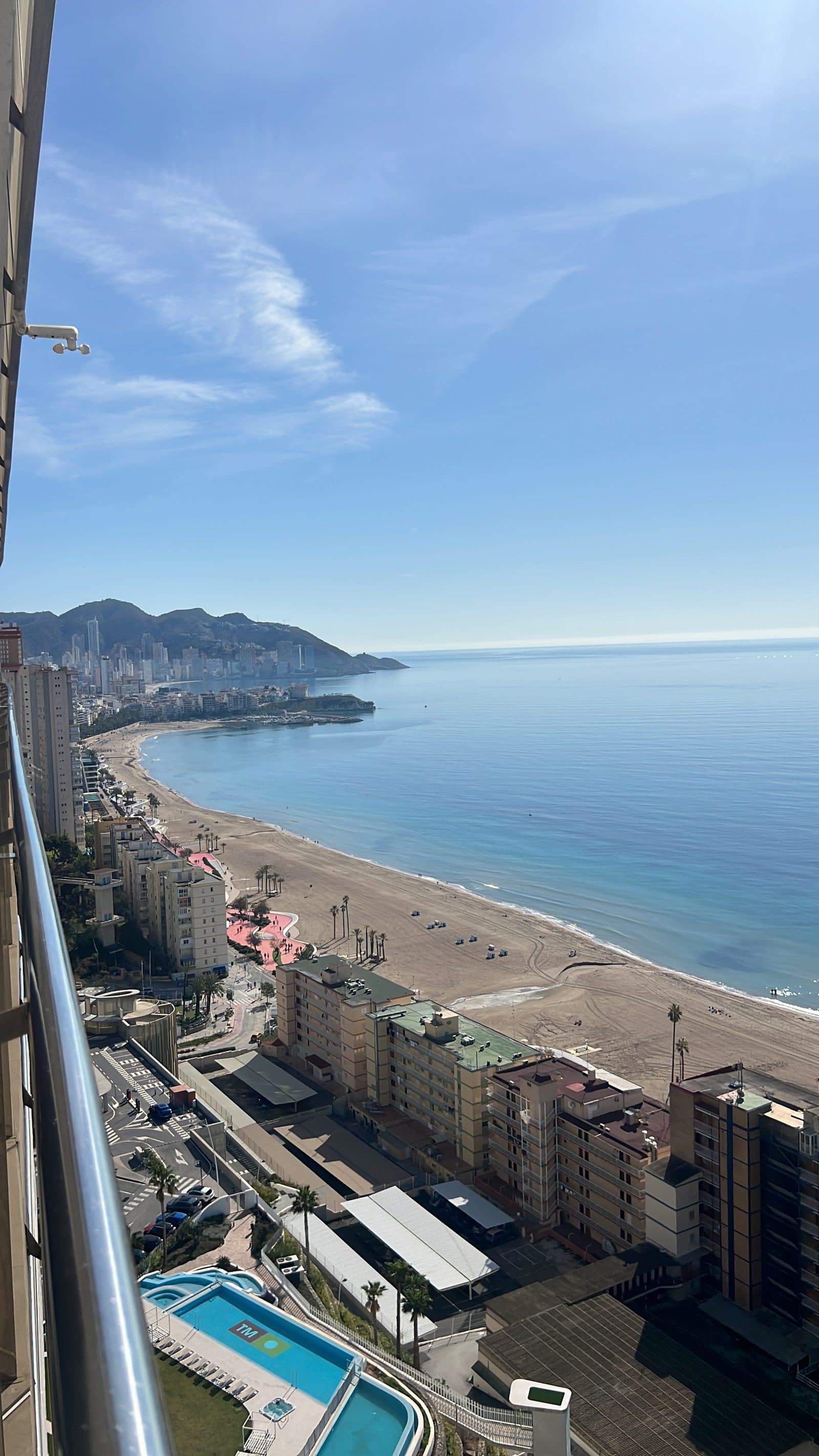 Panoramic view of Poniente Beach from the 18th floor balcony at Sunset Cliffs Benidorm on a clear sunny day