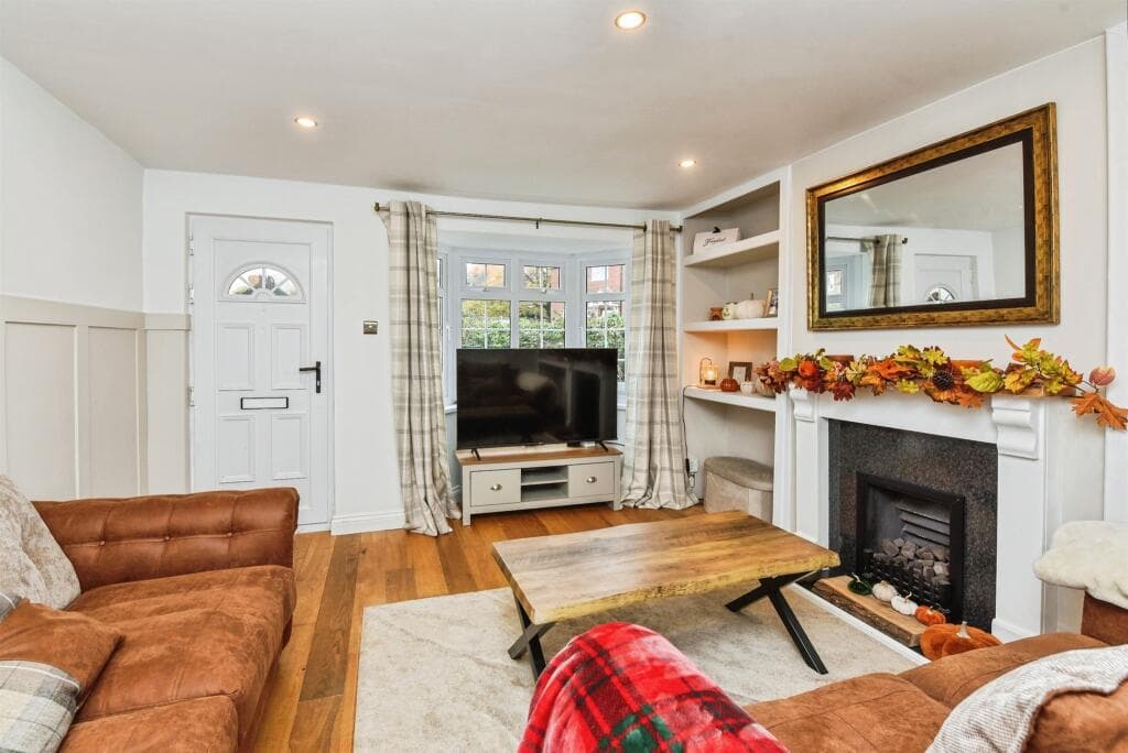 Our Wiltshire cottage living room — the house we rented out on Airbnb to fund our family travel