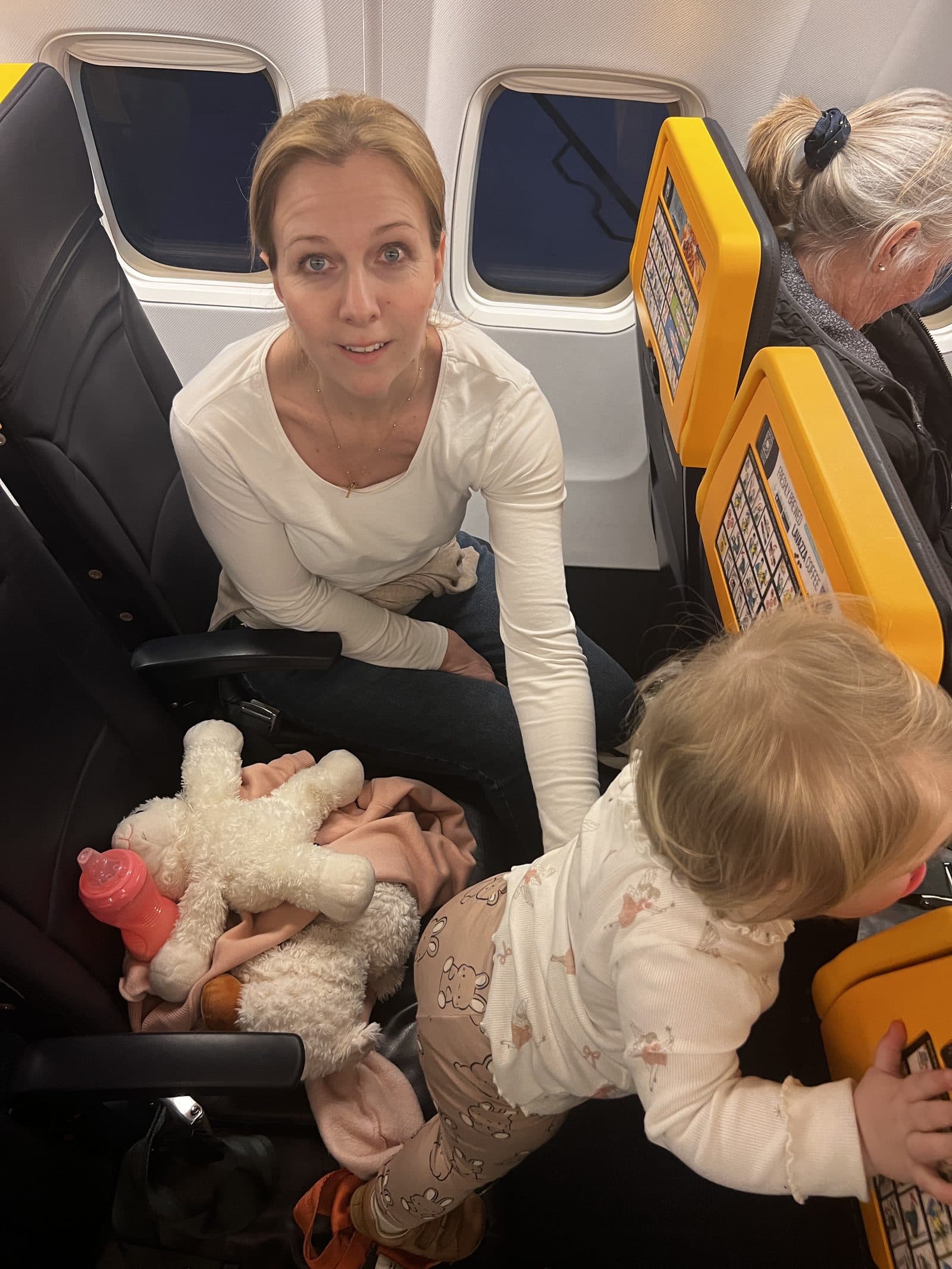 Mum and baby on the Ryanair flight to Benidorm - Tallulah standing on her lap reaching for the seat ahead