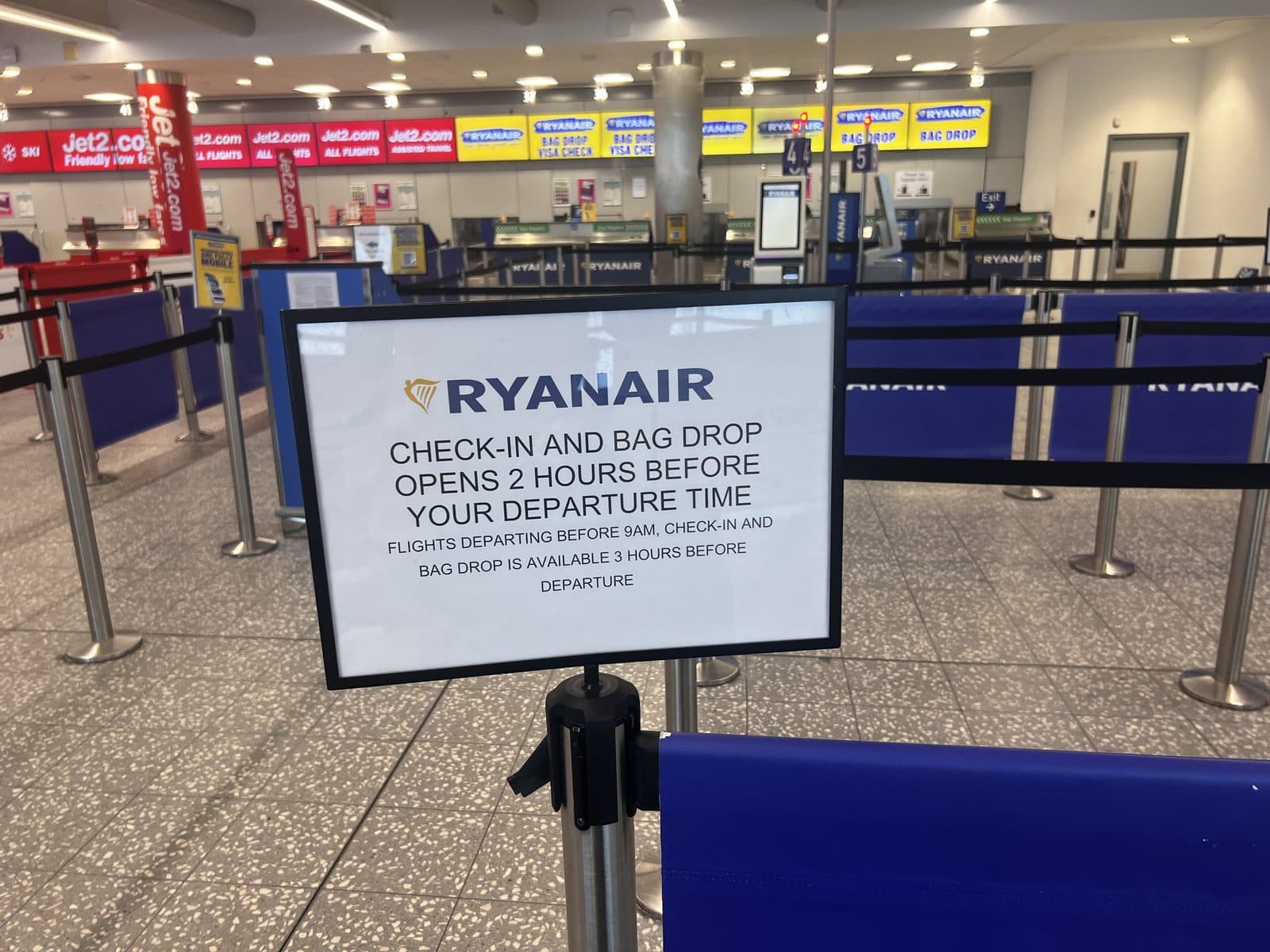 Ryanair check-in sign at Bristol Airport showing bag drop opens 2 hours before departure