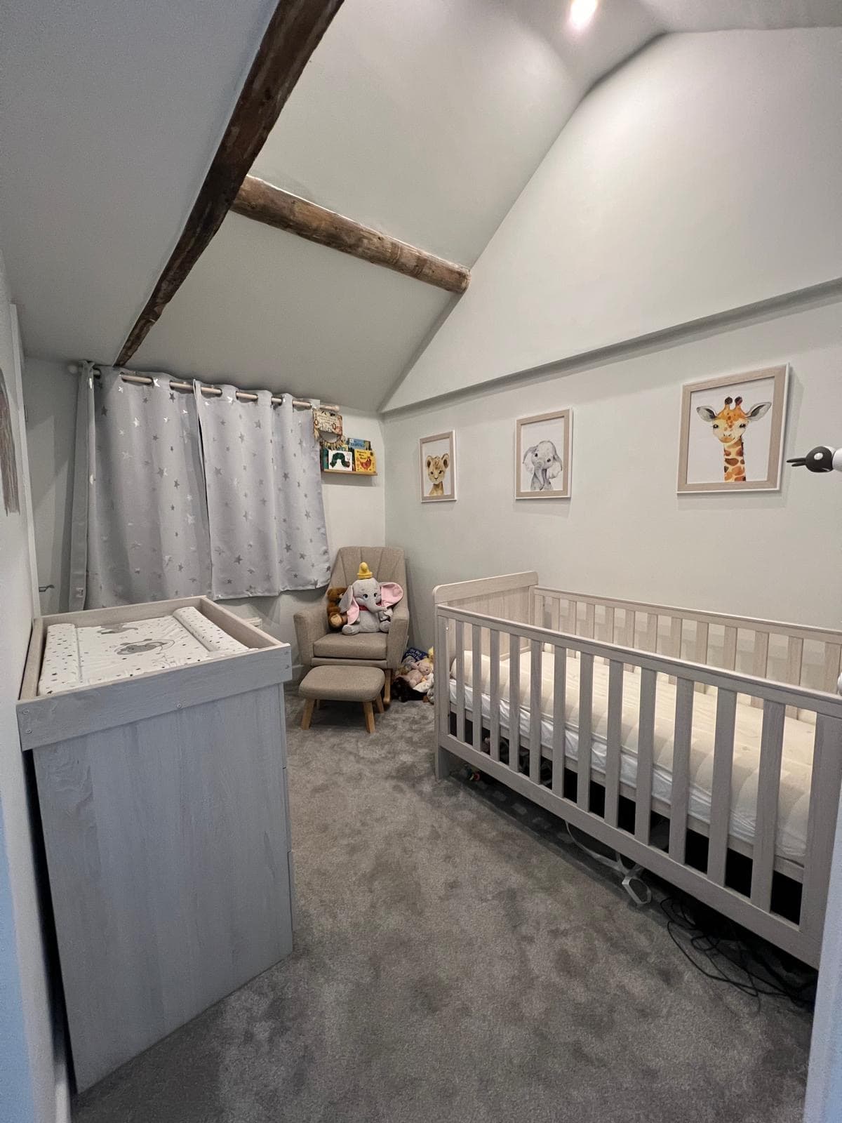 Tallulah's finished nursery in the cottage — cot, animal prints, exposed beams