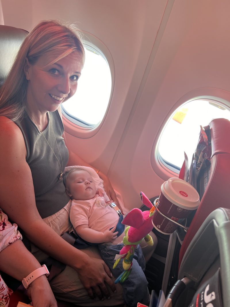 Mum holding sleeping 4-month-old baby on the Jet2 flight to Turkey - baby asleep on lap