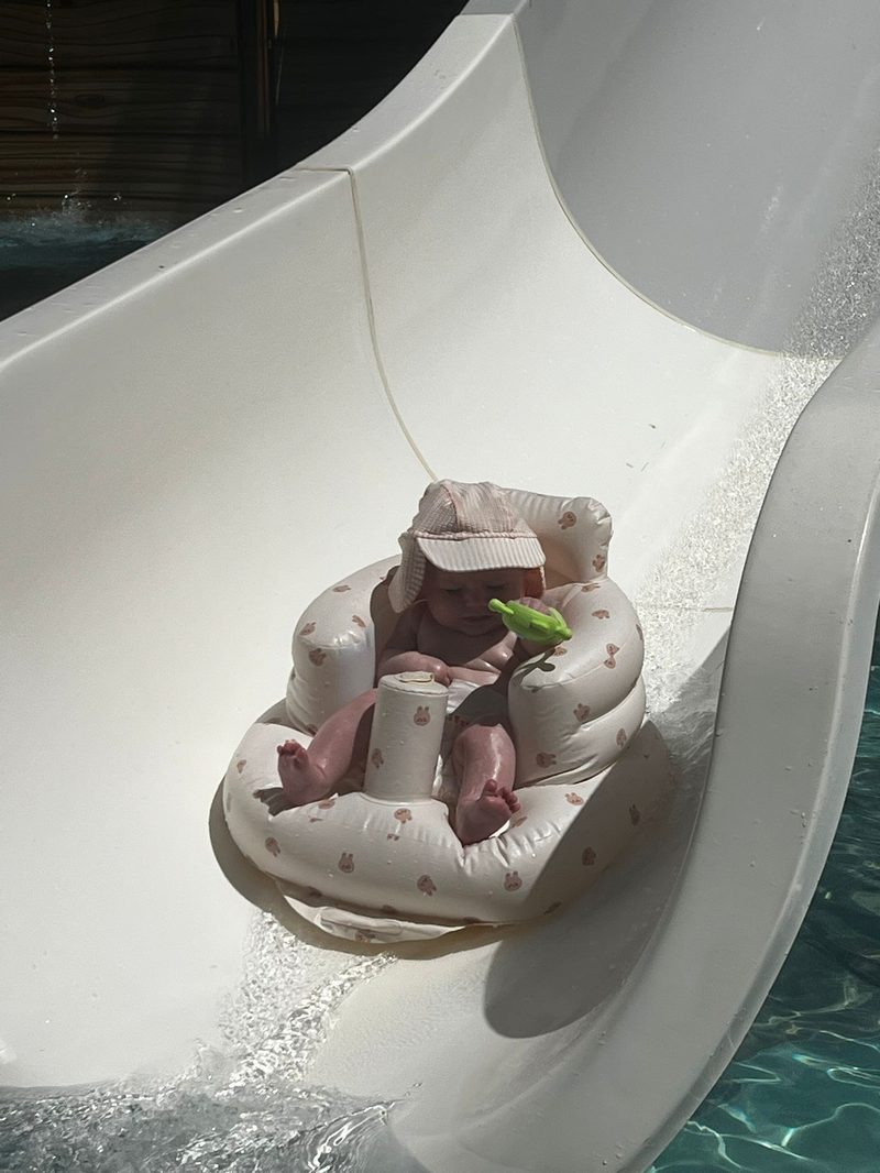 Close-up of baby in inflatable float at the baby pool slide in Akbuk Turkey all-inclusive resort