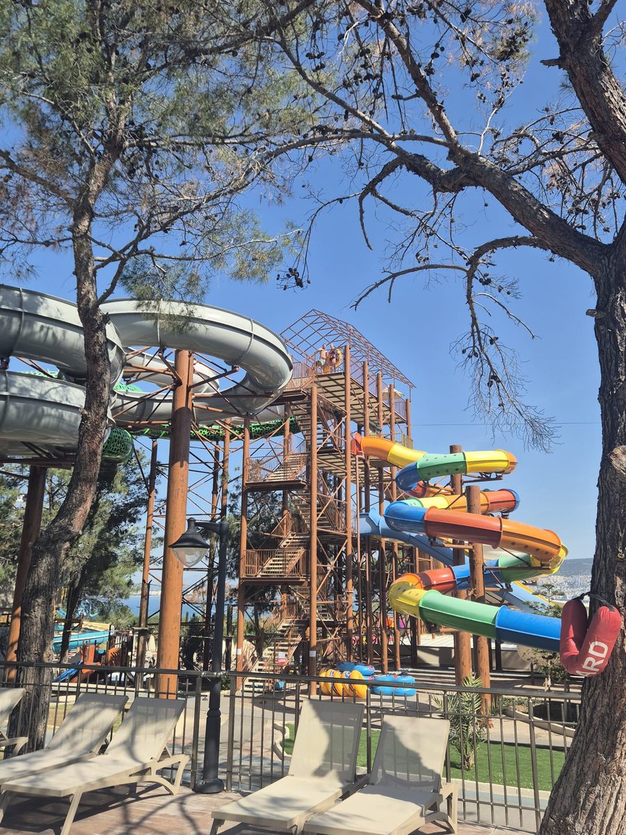 Colourful waterpark slides tower at Long Beach Club Nature all-inclusive resort in Akbuk Turkey